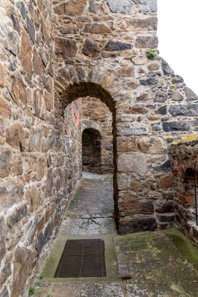 Bautzen, Saxony - Germany - 04-10-2021: Weathered stone arch passage within the reaims of St. Nicholas' Church, Bautzen