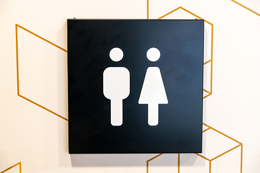 Bautzen, Saxony - Germany - 04-10-2021: Restroom sign with male and female symbols against a hexagonal backdrop