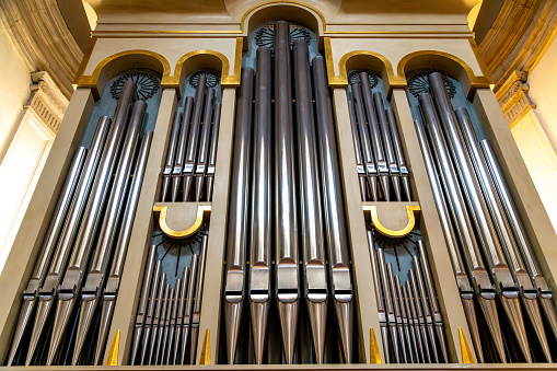 Treviso, Venetien - Italy - 06-08-2021: The intricate pipe organ of cathedral of St Peter the Apostle in in Treviso, beautifully crafted, with golden details