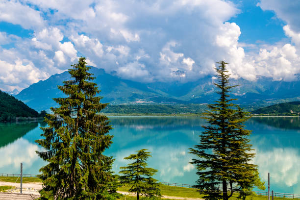 istock Turquoise Lake Surrounded by Pine Trees in Italian Mountains 2127682782