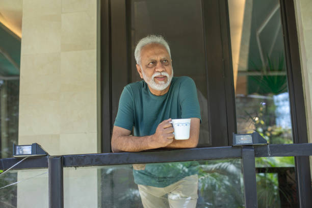 istock Thoughtful retired man with coffee cup at porch 2127702912