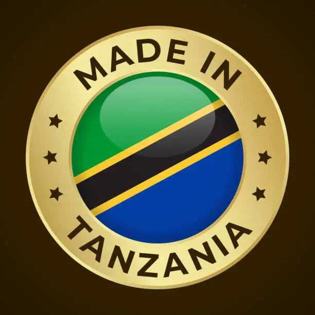 Vector illustration of Made in Tanzania - Vector Graphics. Round Golden Label Badge Emblem with Flag of Tanzania and Text Made in Tanzania. Isolated on Dark Background