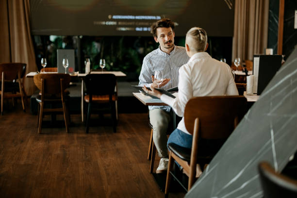 istock Business partners are discussing the menu in a restaurant 2127726940