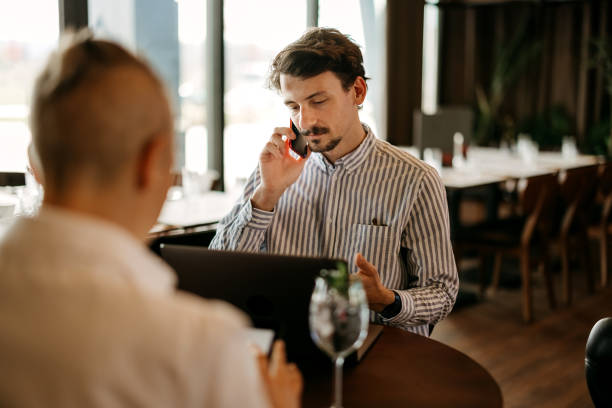 istock Coworkers talking and working in restaurant 2127729019