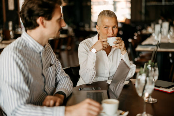 istock Coworkers talking and working in restaurant 2127731587