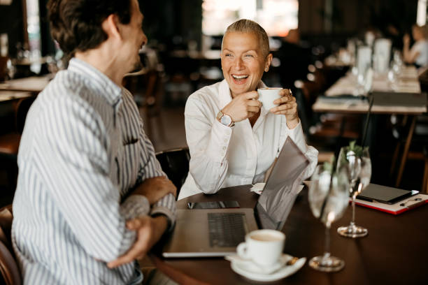 Coworkers talking and working in restaurant