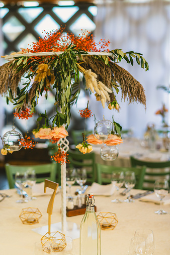 Boho decorated wedding table. Wedding table for a newlywed banquet with eco decor and floral design in the style of boho.