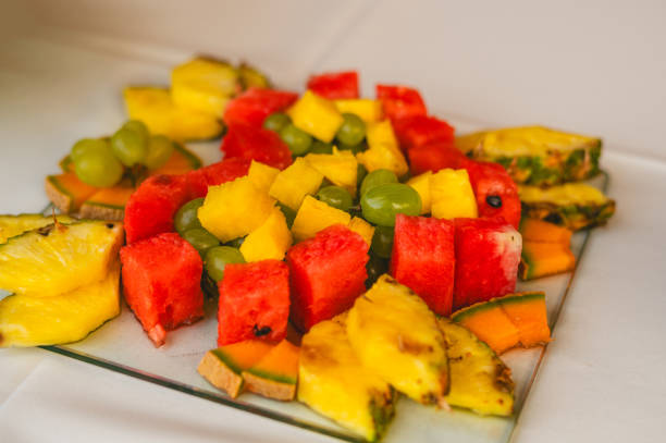 Variety of fruit on a plate, pineapple, melon, grapes, strawberry... decorated