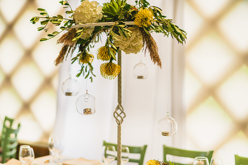 Boho decorated wedding table. Wedding table for a newlywed banquet with eco decor and floral design in the style of boho.