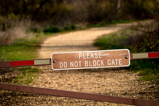 Warning sign about blocking a gate mounted on a gate