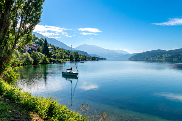 istock Serene Austrian Lake with Anchored Boat and Natural Frame 2127787805