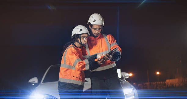 istock White man woman engineer couple work together at outdoor site, teamwork discuss talk using digital tablet at car at night. Work late, overworked, engineering technology concept 2127810132