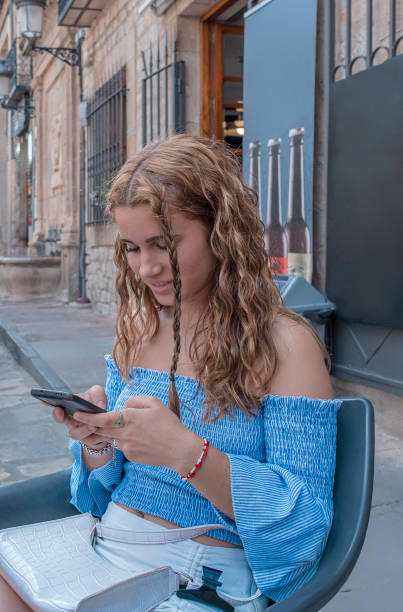 istock Young girl entertained with her mobile. 2127815893
