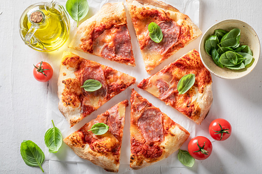 Hot and delicious pizza as perfect dinner in summer. Traditional Italian pizza. Pizza made of cheese and ham.