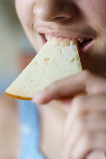 istock Happy anonymous girl biting fresh cheese slice 2127856520