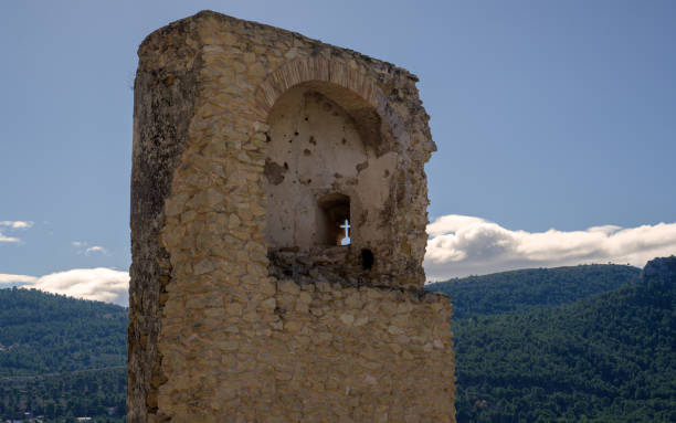 istock Religious cross carved in ancient stone wall. 2127866905