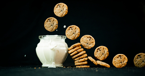 Chocolate chip cookies and fresh milk bowl.