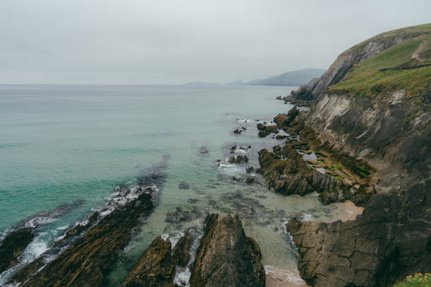 Idyllic view of Irish coast in summer with green meadows and cliffs