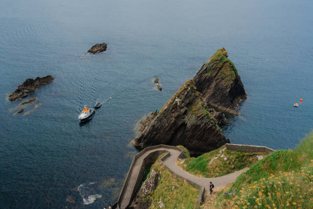 Small tourist boat near the Irish coast at Dingle peninsula in summer