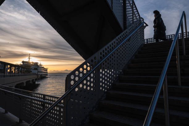 Seattle, USA – Mar 14, 2024: A passenger arriving at the brand-new Colman Ferry terminal on the waterfront in downtown with a docked ferry.