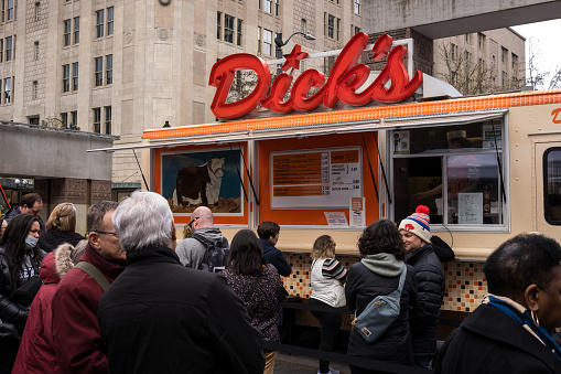 Seattle, USA – Mar 21, 2024: People lined up at the Dicks food truck in Westlake.