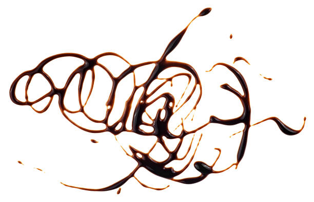 Chocolate syrup drops isolated on a white background, top view. Chocolate topping.