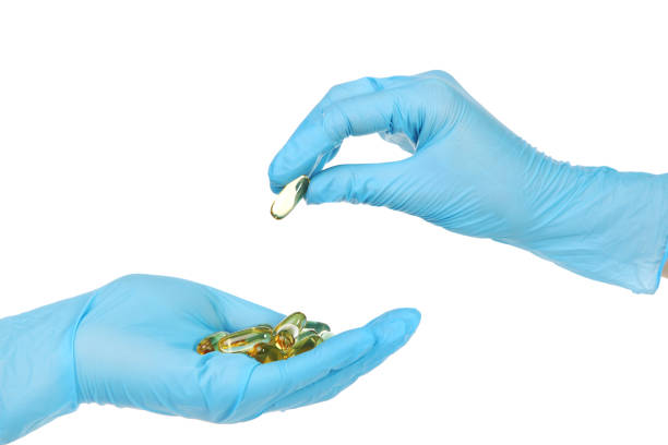 istock Doctor hand in glove holding capsules on white background 2128002062