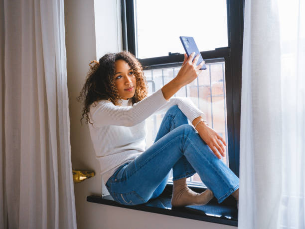 istock Girl taking a selfie for a social media update. 2128017621