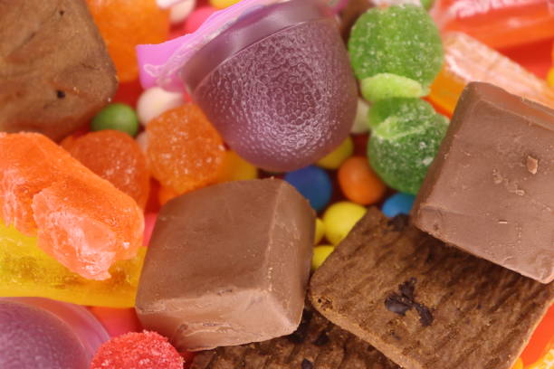 Mix Colorful Candies With Biscuits Closeup