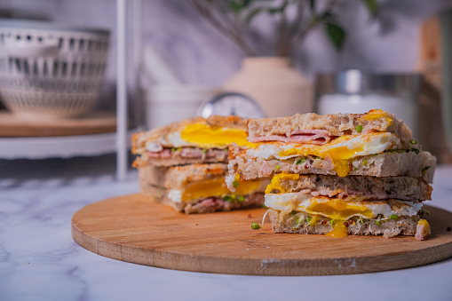 Close-up egg sandwich made with ham and fried egg and sprout for a healthy eating lifestyle. Fresh food for lunch and breakfast.