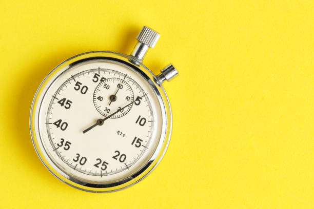istock Mechanical stopwatch yellow background closeup. 2128063974