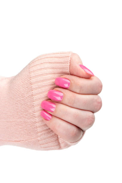 istock Feminine hand with stylish pink manicure on fingers. 2128070821