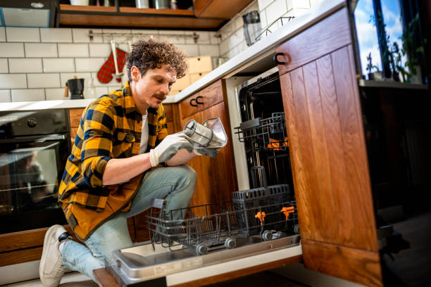 istock Latino man fixing dishwasher in the kitchen. 2128084897
