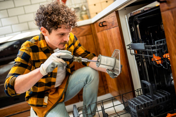 istock Latino man fixing dishwasher in the kitchen. 2128084903