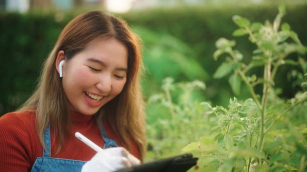 istock Young woman farmer taking order at farm. 2128111538