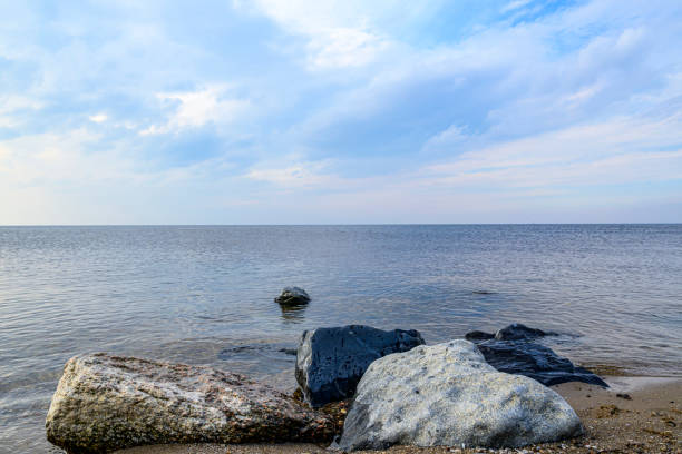 Wide open landscape at the IJsselmeer lake at the former island of Urk in Flevoland on March 31 in The Netherlands. The IJsselmeer, former Zuiderzee sea is a lake with an artifical dam, afsluitdijk in The Netherlands.