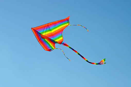 A single kite under the blue sky