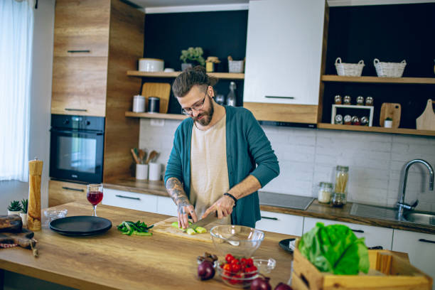 istock Man is preparing a salad in the kitchen 2128188305