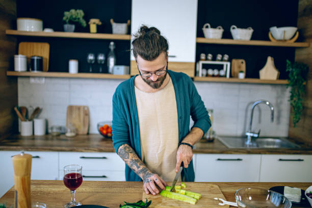 istock Man is preparing a salad in the kitchen 2128193708