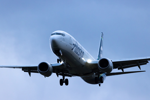 Portland, Oregon, USA - March 3, 2024: An Alaska Airlines Boeing 737-900 coming in for landing at Portland International Airport.