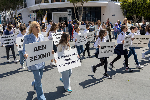 Limassol, Cyprus, March 25th, 2024: People with banners during Greek Independence Day parade