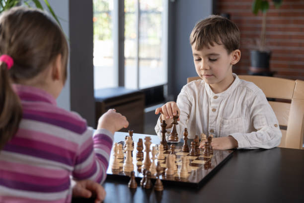Children playing chess at home