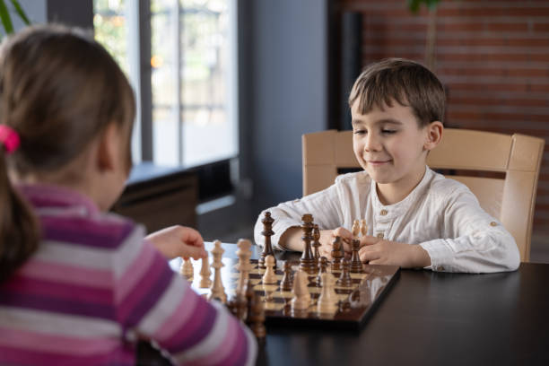 Children playing chess at home