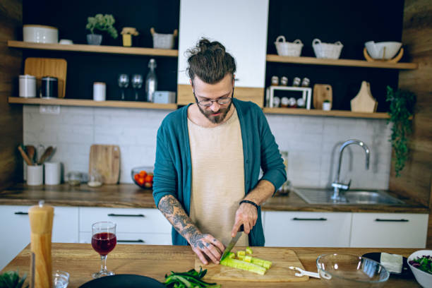 istock Man is preparing a salad in the kitchen 2128198403