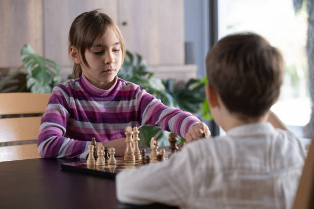 istock Children playing chess at home 2128198918