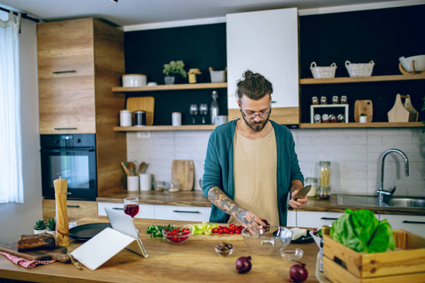 istock Man is preparing a salad in the kitchen 2128202057