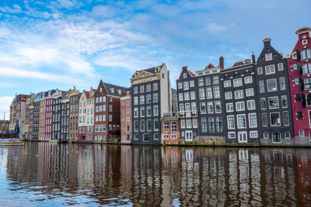 istock Amsterdam downtown - Amstel river, old houses and a bridge 2128213106