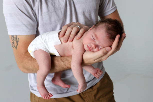 istock Father holding newborn baby 2128215281