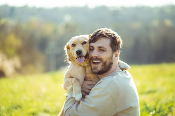 istock Guy and his dog, golden retriever, nature 2128216749