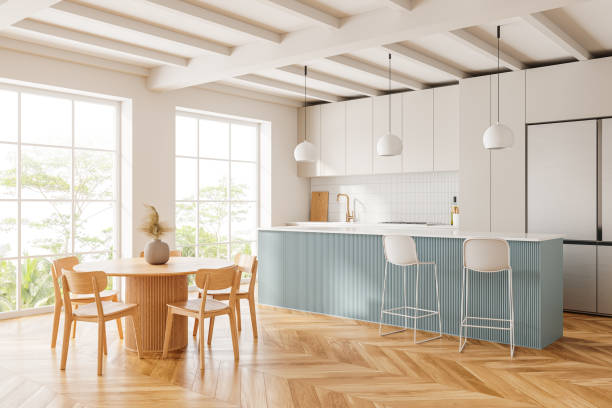 istock Stylish home kitchen interior with bar island and eating table with window 2128251011